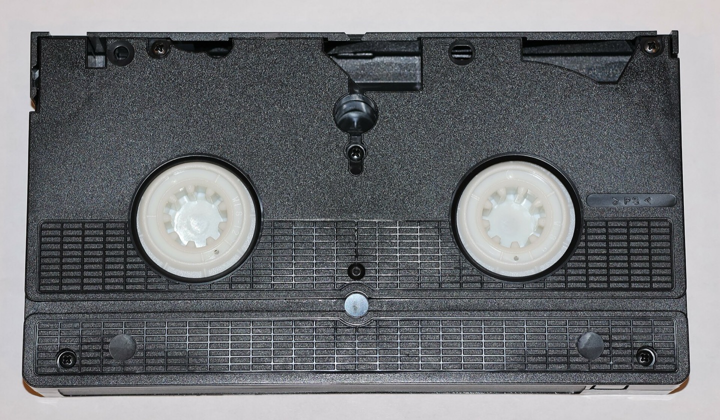 Back side of a VHS tape on a neutral background