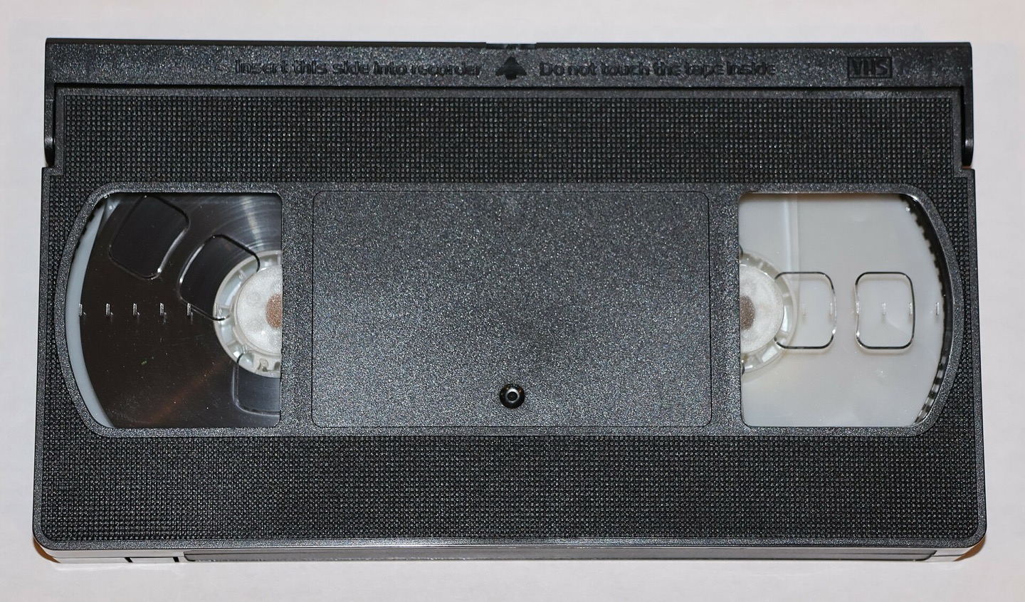 Front of a VHS tape against a neutral background