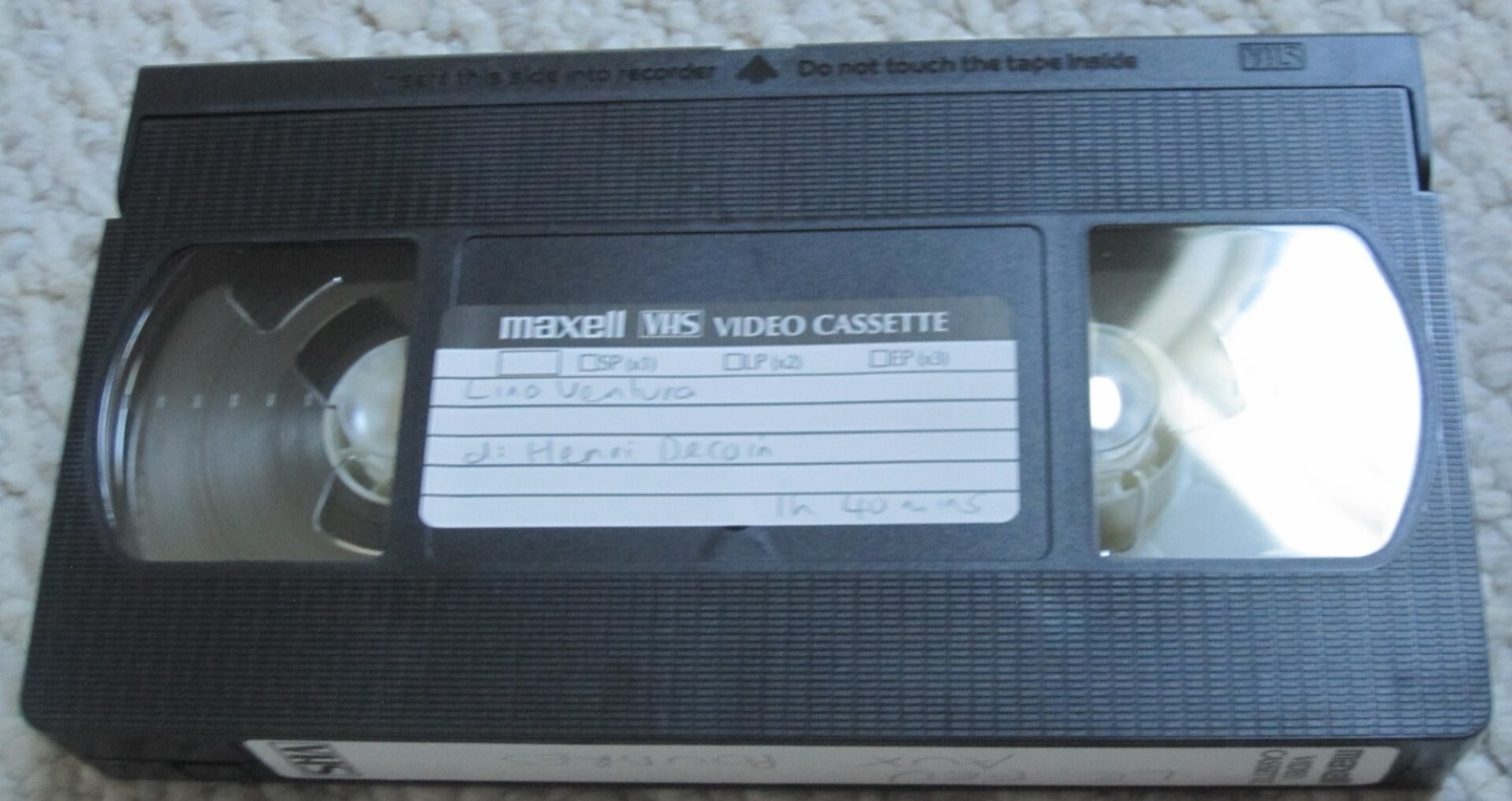 Front side of a VHS tape on a neutral background